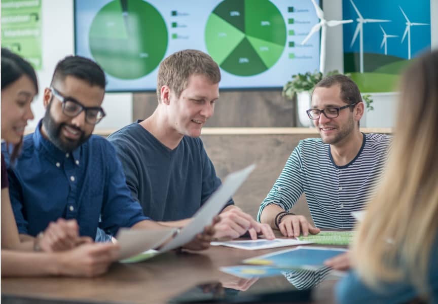 Coworkers in a meeting reviewing charts